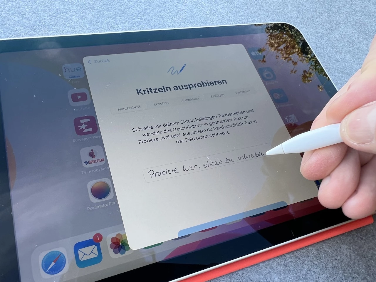 A person using an Apple Pencil on an iPad to take notes.