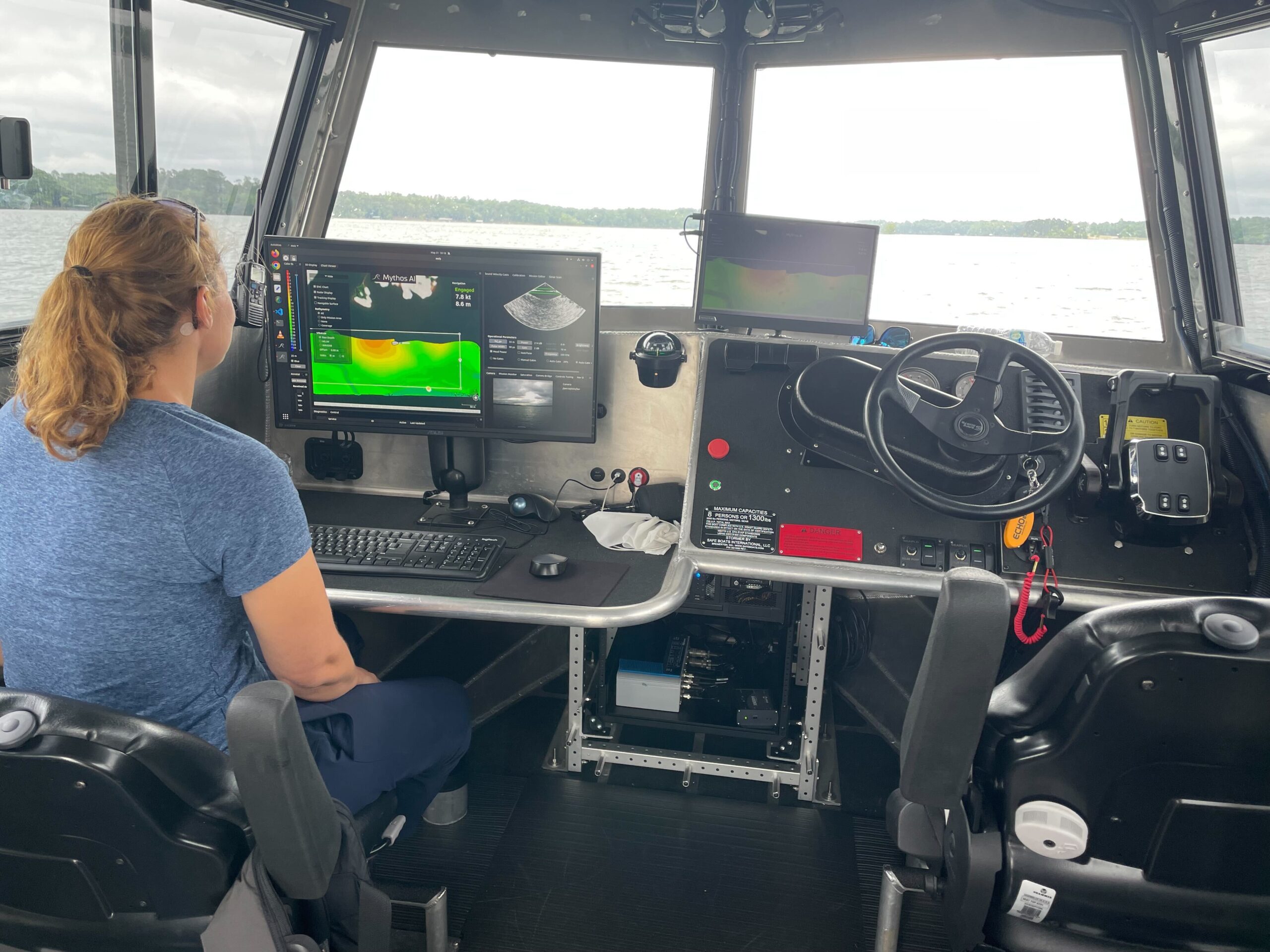 A person using the Smythos AI platform at a control station with monitors.