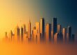 A clean, minimalist image of an abstract cityscape silhouette in warm tones.