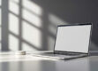 Minimalist desktop scene with modern laptop and virtual assistant icon.