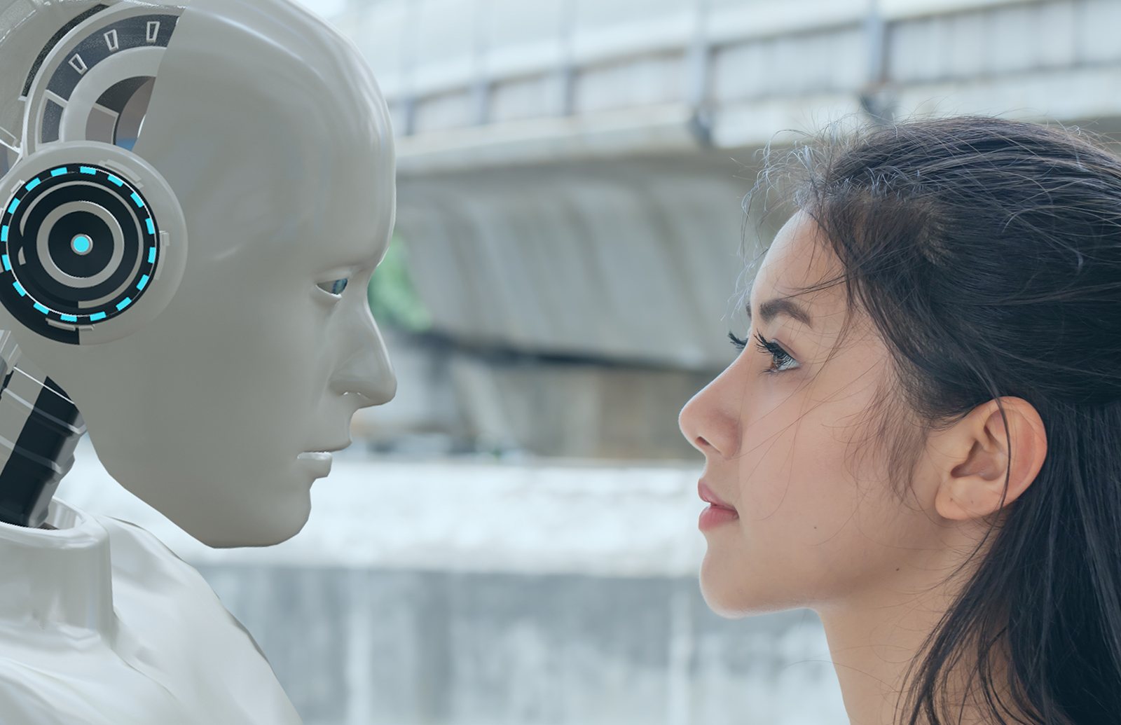 A humanoid robot and a young woman gazing at each other