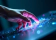A polished human hand reaching out to a glowing digital hand.