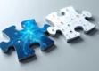 A professional photo of two modern puzzle pieces interlocking, one with a blue digital pattern and the other with email icons, casting soft shadows.