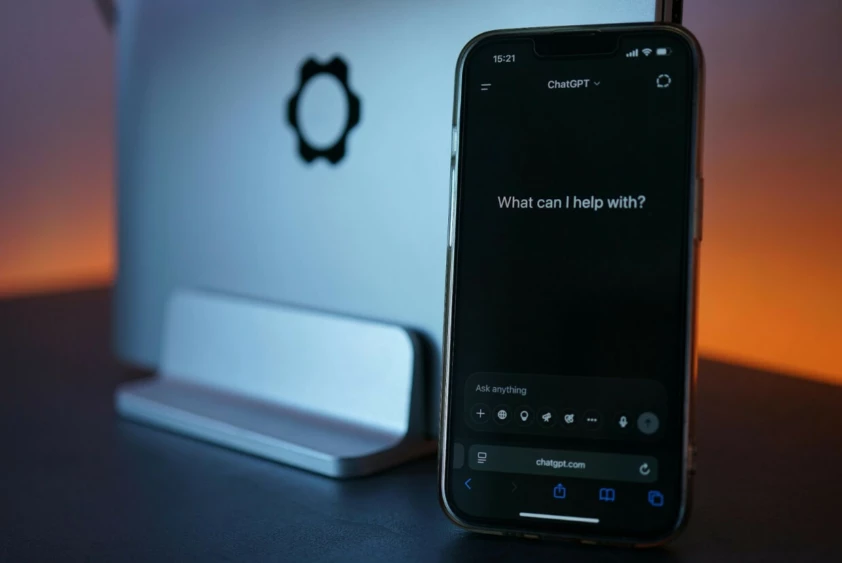 a modern smartphone displaying the ChatGPT dark-mode interface